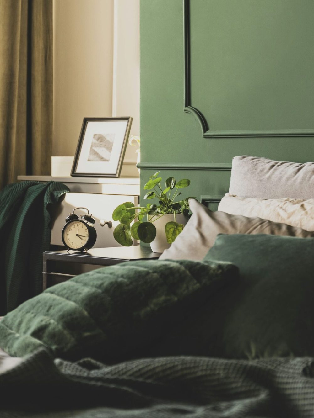 Dark green trendy interior design in fashionable apartment, copy space on empty wall